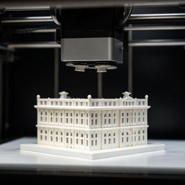 Close-up of 3D printer creating an architectural building model in white resin, studio lighting, high-resolution, no text.